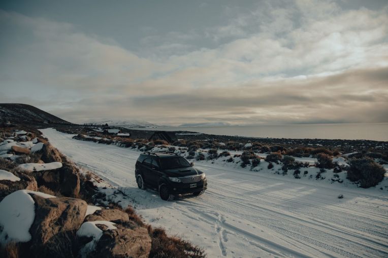 Car with winter tyres on a snow-covered road